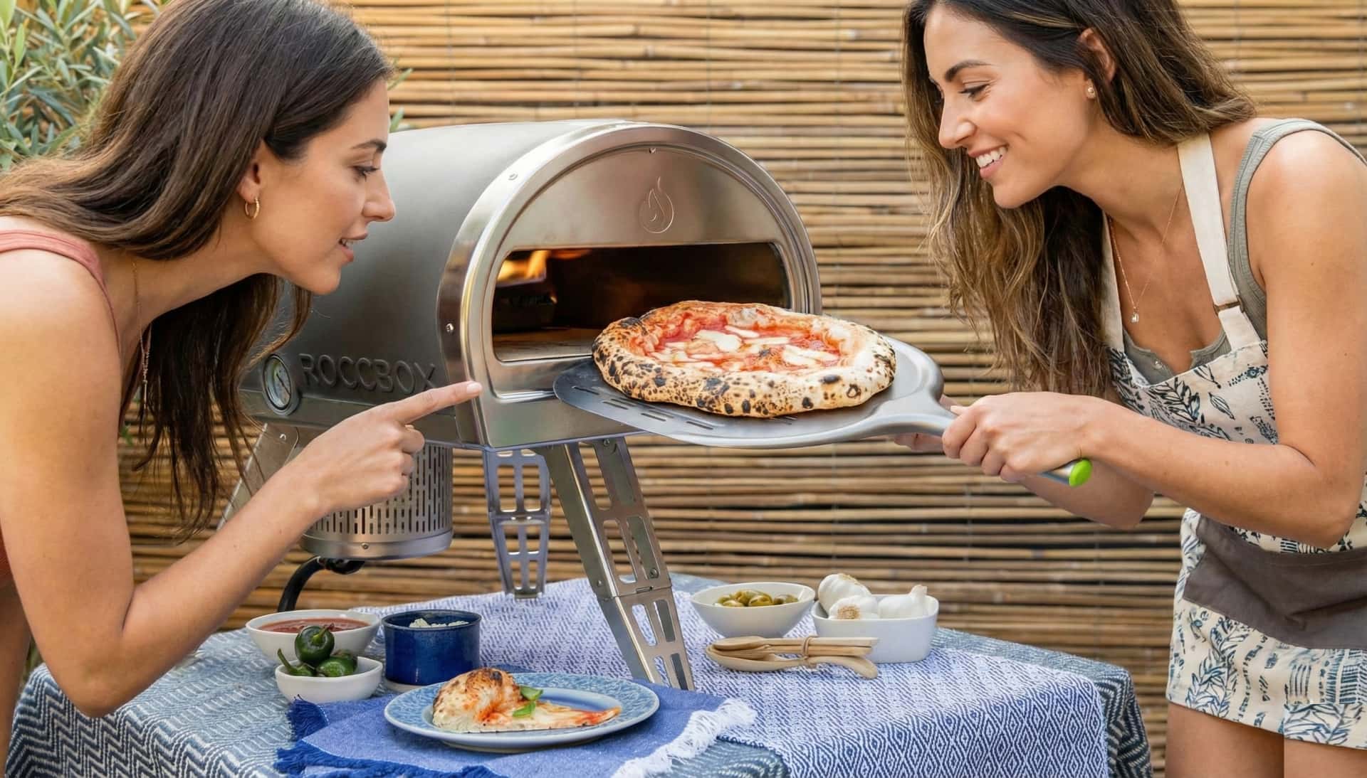 Testing portable wood fired pizza ovens on a backyard table.
