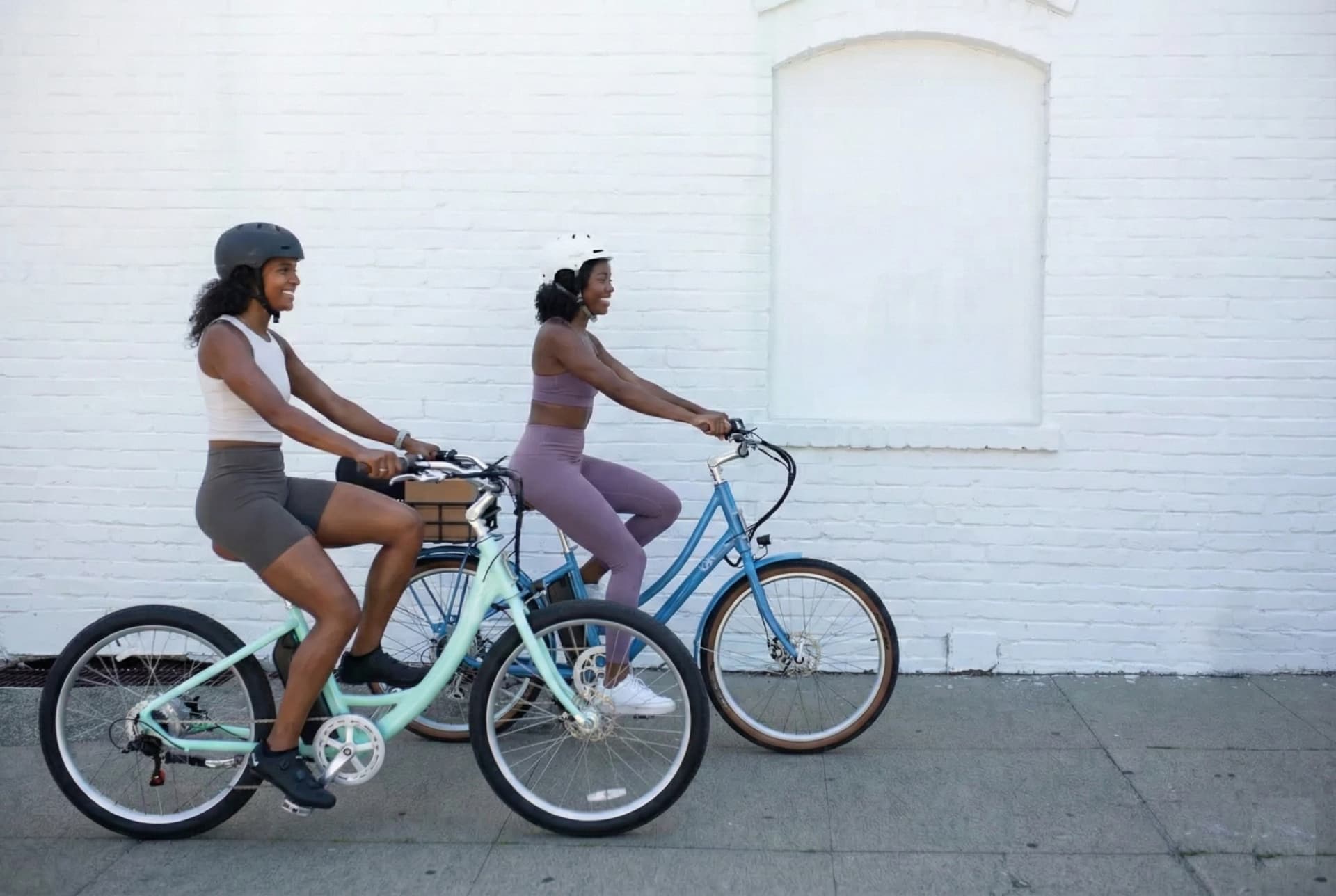 Modern commuter riding a sleek ebike past city bike lanes at sunrise